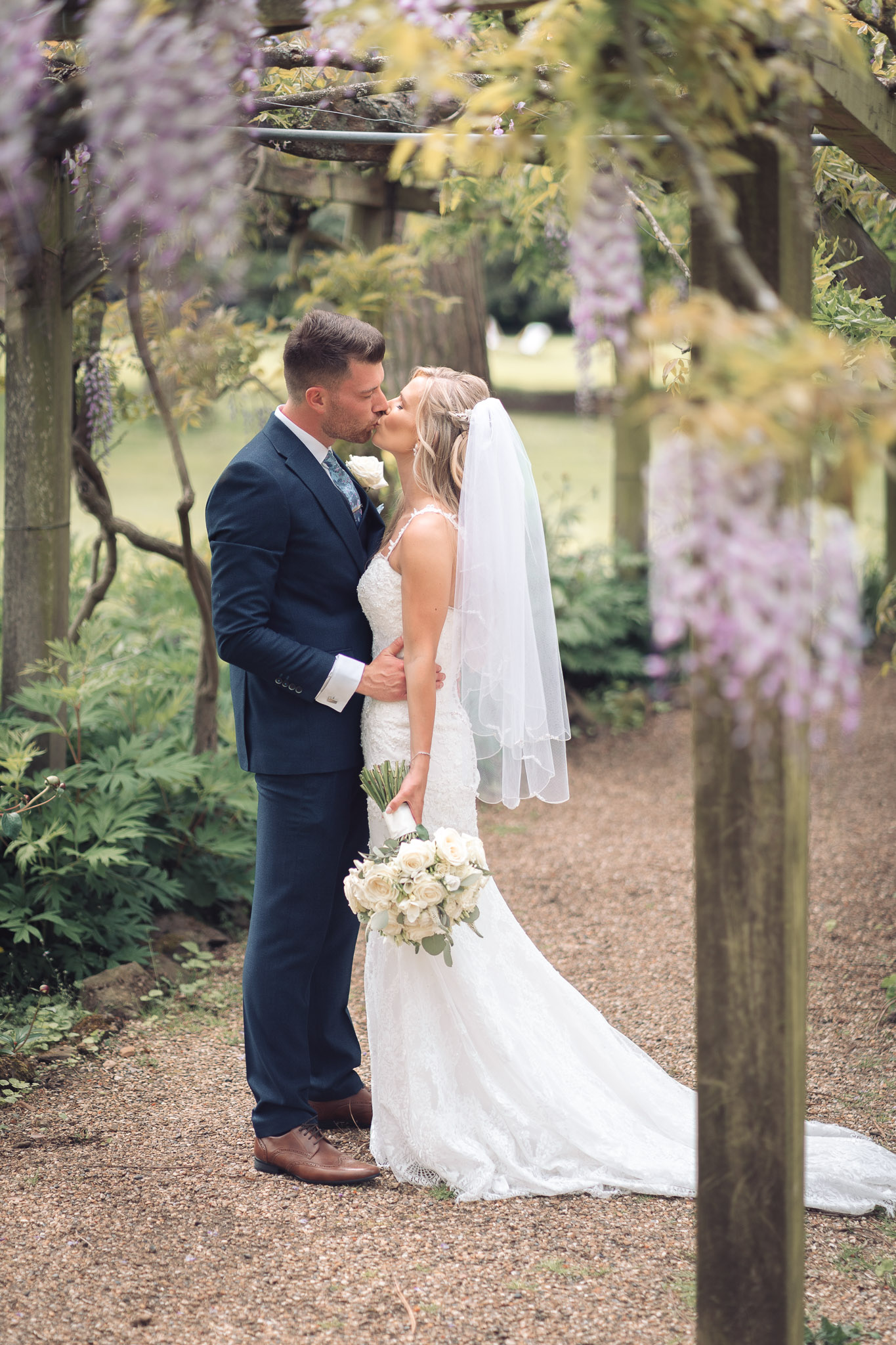 bride and groom at fanhams hall May wedding in wisteria