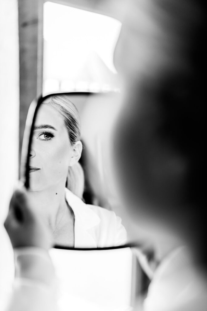 Bride looking at her bridal make up in mirror