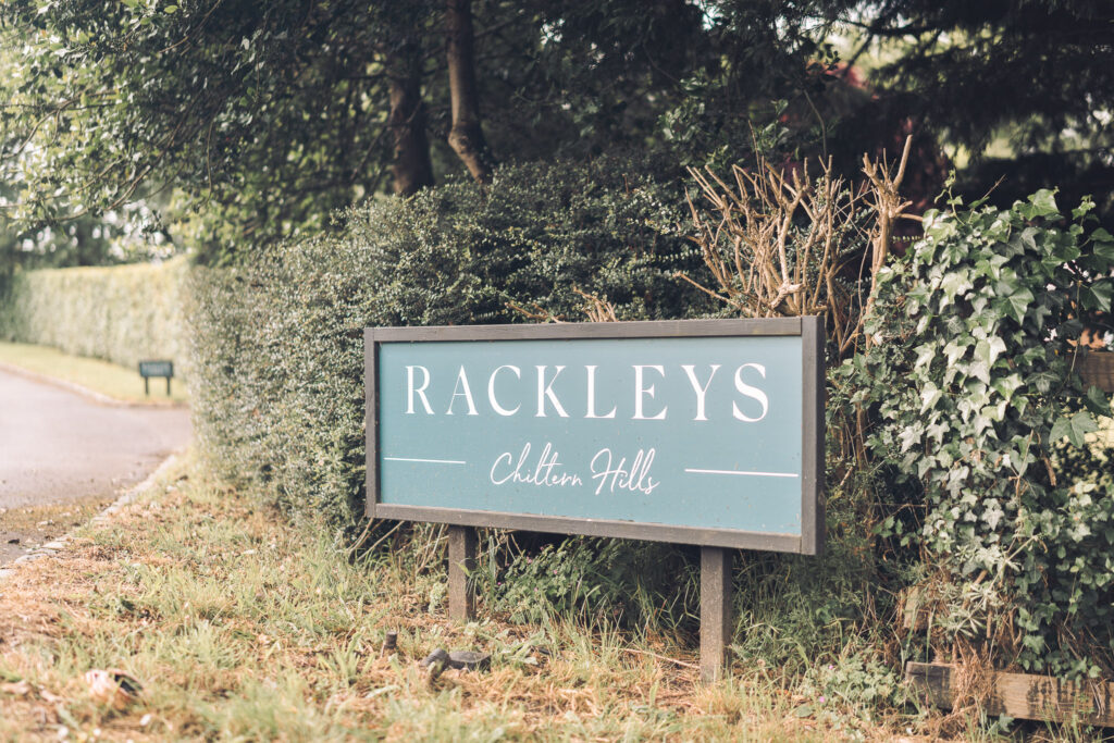 Entrance sign to beautiful wedding venue Rackleys in the Chiltern Hills, surrounded by greenery